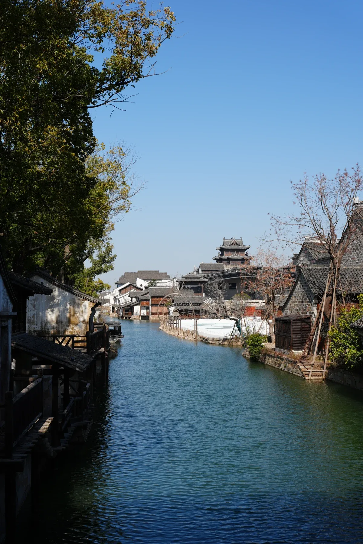 Owner-supplied vertical photograph of a canal and traditional waterside buildings under a blue sky